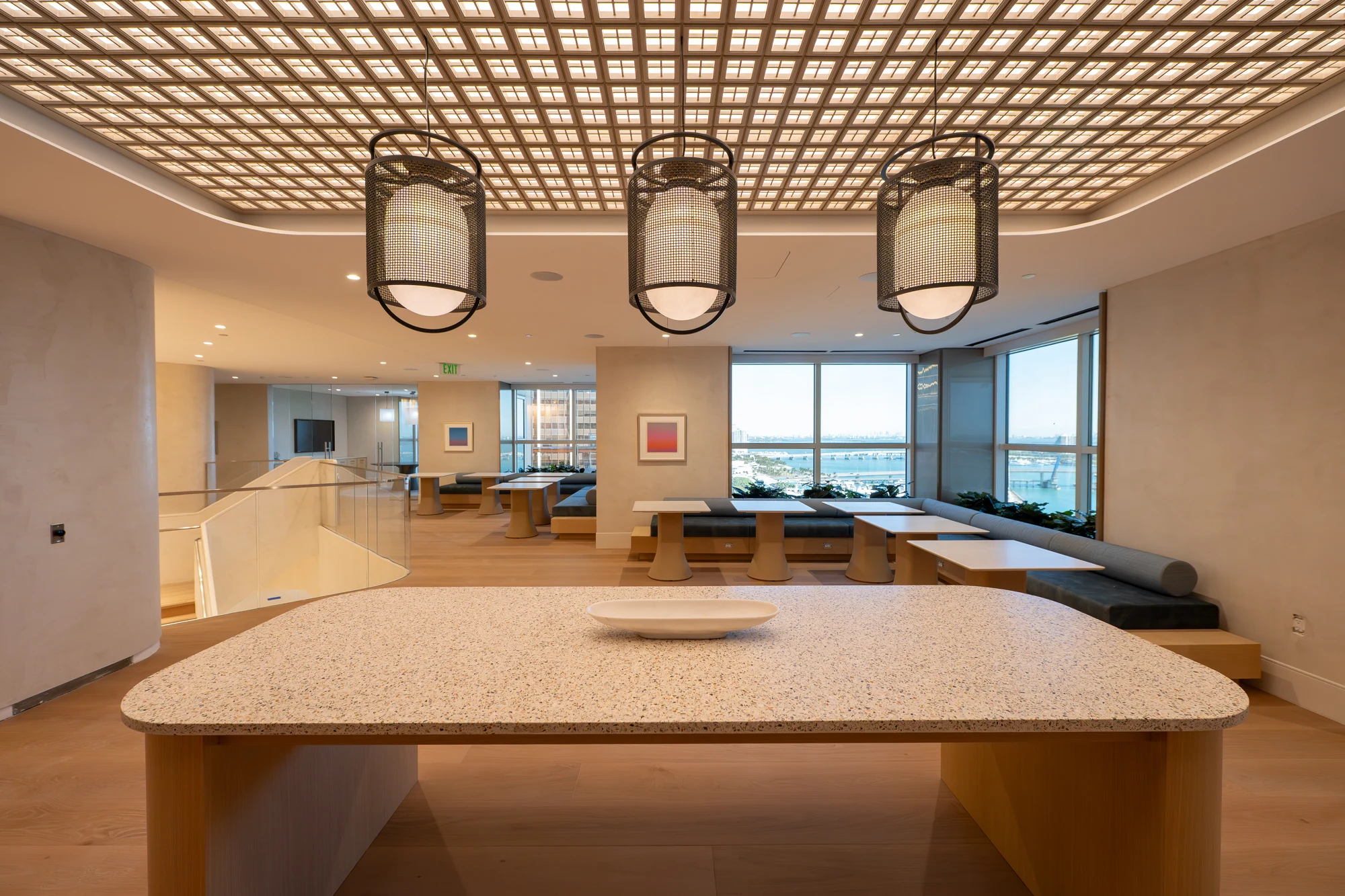 Winston & Strawn lounge with a lattice ceiling, pendant lights and warm wood finishes