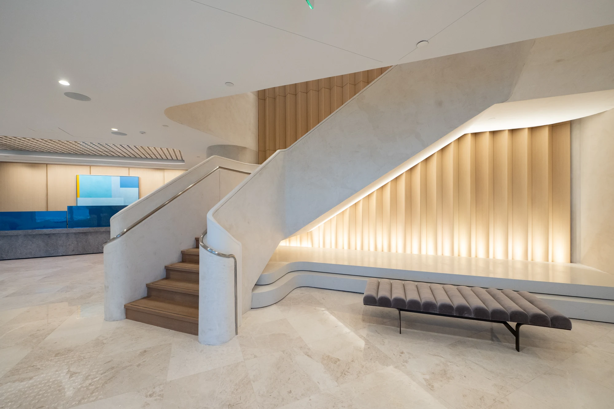 Sculptural staircase and warm architectural finishes at Winston & Strawn in Miami